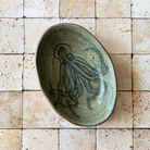 Ceramic plate with an octopus design on a tiled wall