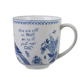 A white ceramic mug with blue floral illustrations and cursive text, set against a plain white background.
