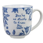 A white ceramic mug with a blue floral pattern and the handwritten text 'You're so lucky to know me' on the side, set against a plain white background.